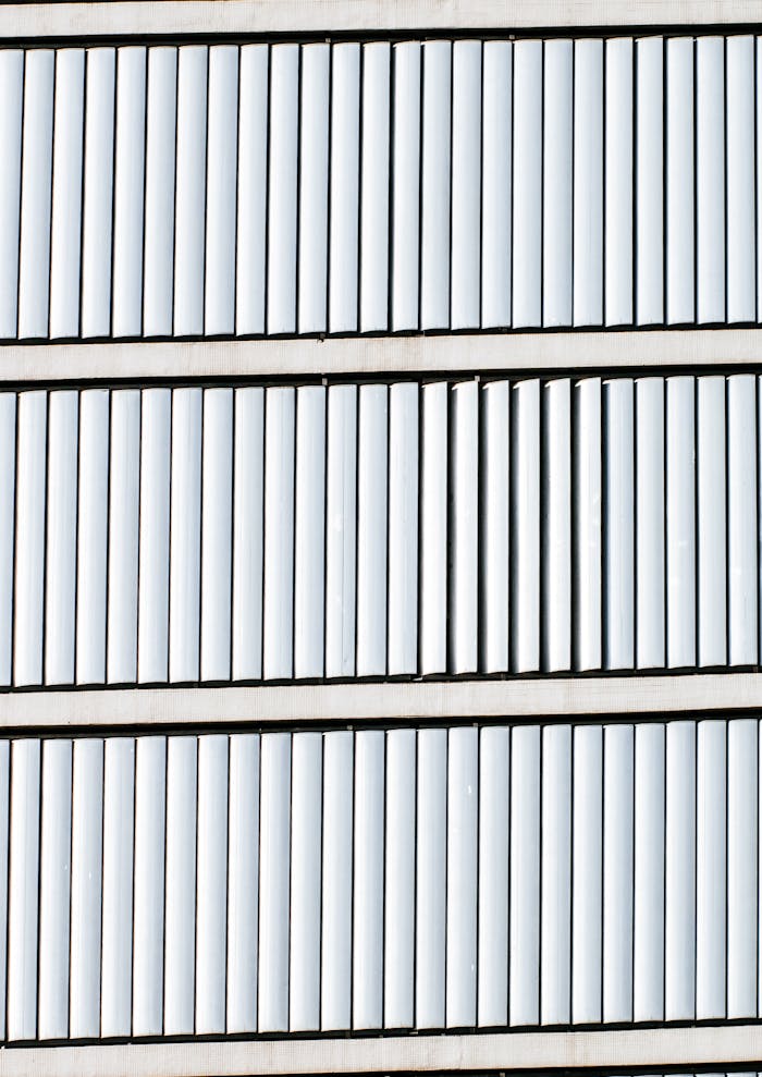 Close-up of a modern building facade featuring vertical window blinds.